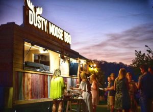 Customers being served by the Dusty Moose BBQ food trailer