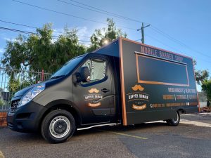 Side view of the Dapper Domain mobile barber shop truck.