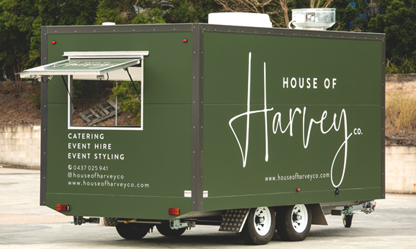 Side view of House of Harvey’s catering van.