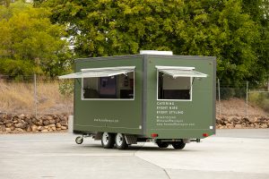 Side view of House of Harvey’s catering van.