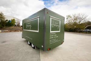 Side view of House of Harvey’s catering van.