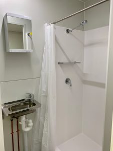 Inside view of the Room2Move accommodation trailer shower.