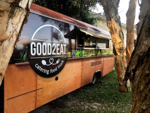 Side view of the Good2Eat Catering bus.