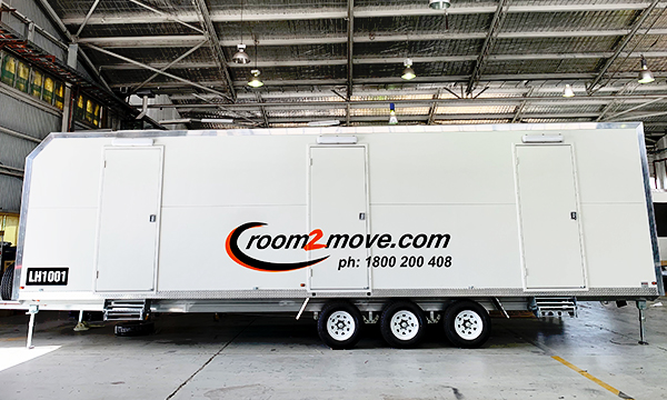 Side view of the Room2Move accommodation trailer.