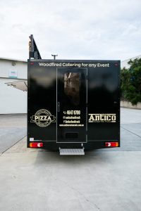 Rear view of the Antico woodfire pizza truck.