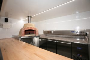 Inside view of the Antico woodfire pizza truck kitchen.
