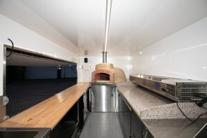 Inside view of the Antico woodfire pizza truck kitchen.