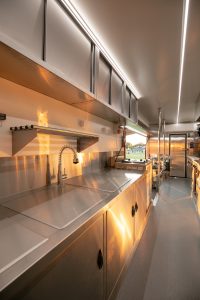 Inside view of Robbie’s Roadside Diner truck and trailer combo kitchen